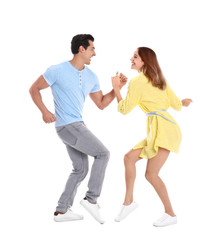 Beautiful young couple dancing on white background