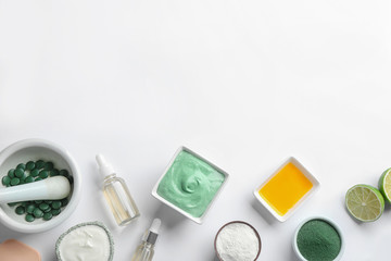 Plakat Composition with spirulina facial mask and ingredients on white background, top view