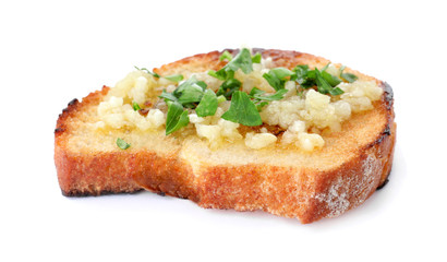 Slice of toasted bread with garlic and herb on white background