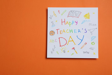 Paper with inscription HAPPY TEACHER'S DAY on orange background, top view. Space for text