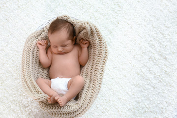 Cute little baby sleeping in cradle on light background, top view. Space for text