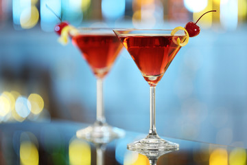 Glasses of fresh alcoholic cocktail on bar counter