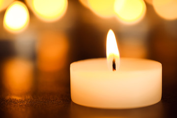 Obraz na płótnie Canvas Burning candle on table, closeup. Funeral symbol