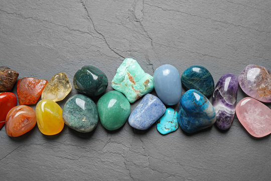 Flat lay composition with different gemstones on grey table