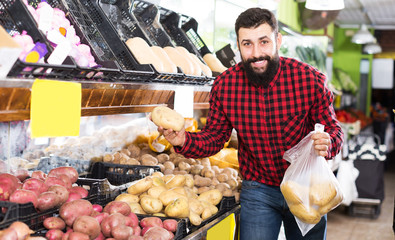Young male seller offering pears