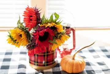 Red and yellow sunflowers in vintage plaid tin
