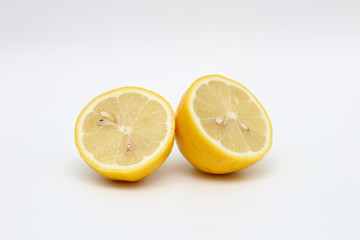 Fresh, ripe, isolated, juicy bisected lemon on a white background. Studio macro shoot