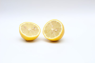 Fresh, ripe, isolated, juicy bisected lemon on a white background. Studio macro shoot