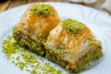 baklava with pistachios on wooden table. Turkish cuisine