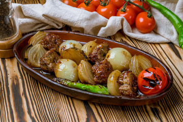 Beef kebab with onions in Turkish on the board
