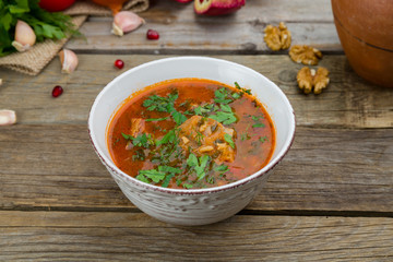 soup kharcho on bowl on old wooden table