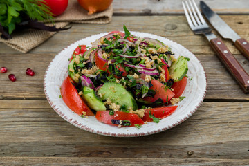 vegetable salad with nuts on old wooden table