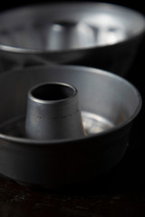 Vintage baking pans on a dark wood table