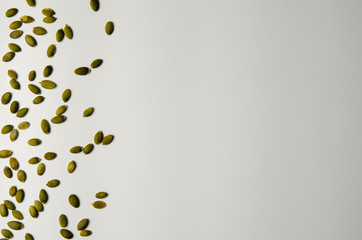 Pile of green pepita pumpkin seeds isolated on white
