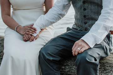 Wedding couple sitting together holding hands