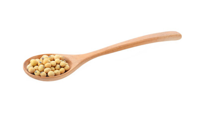 Soy beans in woodenspoon  isolated  on white background