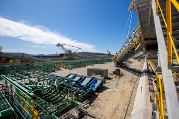 The territory of the marine coal terminal. Construction site of a coal terminal. Warehouse with building materials on the seashore.