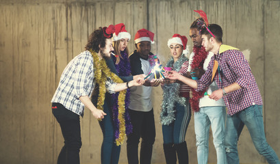 multiethnic group of casual business people lighting a sparkler