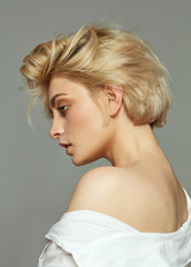 Face profile of blonde woman with short hair