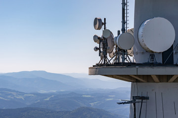 Directional radio antennas on a radio tower over the mountain peaks of the Black Forest, Germany