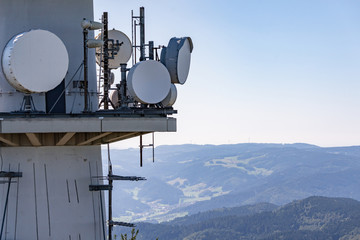 Directional radio antennas on a radio tower over the mountain peaks of the Black Forest, Germany