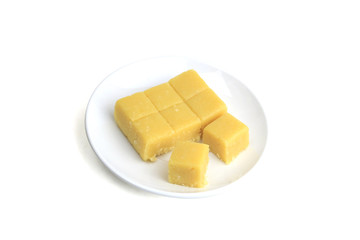 Mung bean cookies on plate isolated on white background.  Delicious golden yellow Thai sweet dessert made from streamed mung bean, coconut milk and sugar.