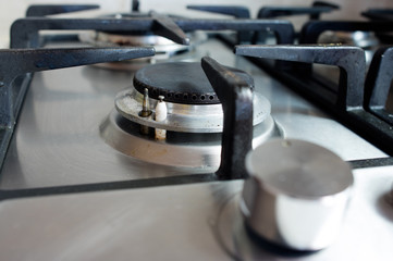 Filthy gas stove in the kitchen. Closeup to one of the burners.