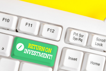 Text sign showing Return On Investment. Business photo showcasing perforanalysisce measure used evaluate efficiency of investment White pc keyboard with empty note paper above white background key