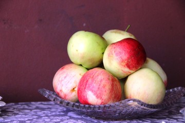still life many red-yellow apples on the table in brown and violet tones. ripe red apples and yellow apples on the table.
