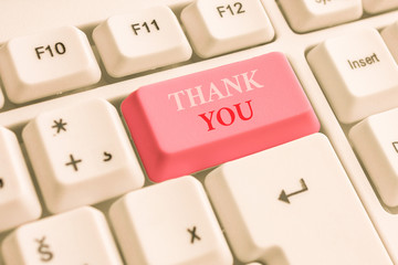 Text sign showing Thank You. Business photo text polite expression used when acknowledging gift service compliment White pc keyboard with empty note paper above white background key copy space