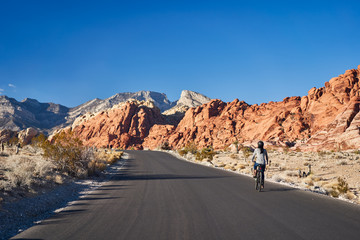 african american woman riding bicycle through red rock canyon park