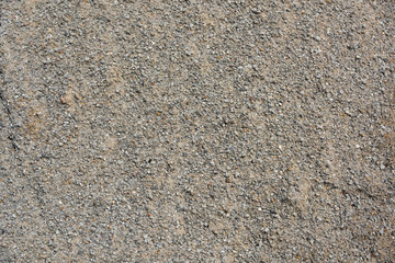 Closeup of damp grey concrete gravel background for building