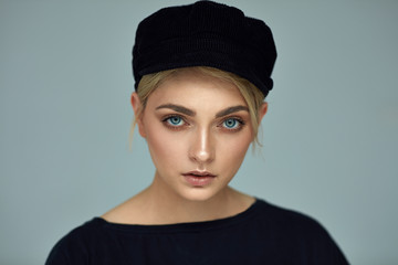 Beauty portrait of fashion young model with black cap
