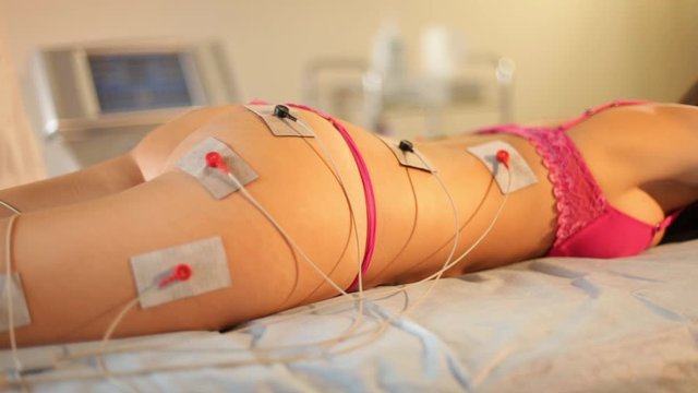 Muscle contractions in electro myo stimulation therapy of the butt, legs and back. Hardware cosmetology and antiage therapy