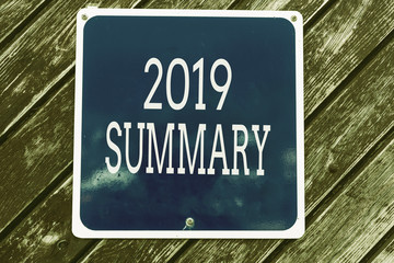 Obraz premium Handwriting text writing 2019 Summary. Conceptual photo brief comprehensive especially covering the main points of 2019 Empty blue board with copy space above wooden background