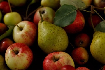 Background from ripe juicy pears and apples for your design. Close-up. Harvest.