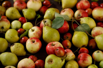 Background from ripe juicy pears and apples for your design. Close-up. Harvest.