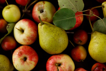 Background from ripe juicy pears and apples for your design. Close-up. Harvest.