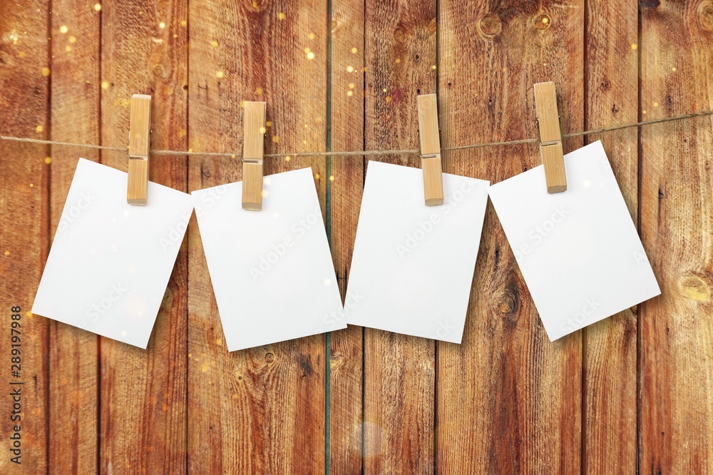 Sticker Blank white papers hanging on rope isolated on white background