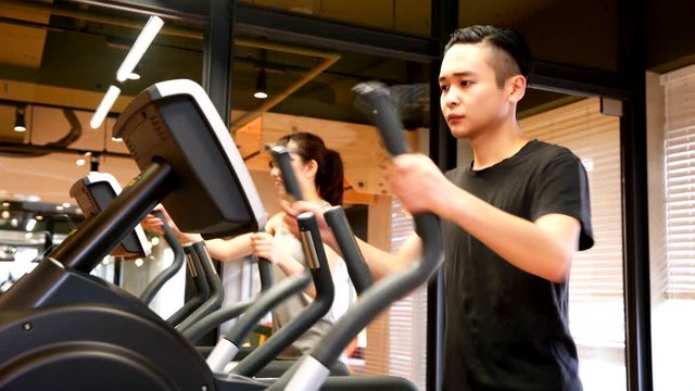 一緒にクロストレーナーで運動をするカップル
