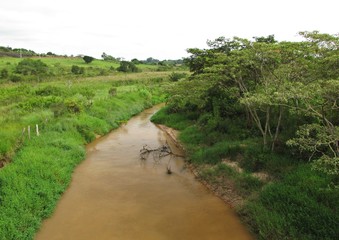 Fototapeta na wymiar A river with erosion and without riparian forest - Brazil
