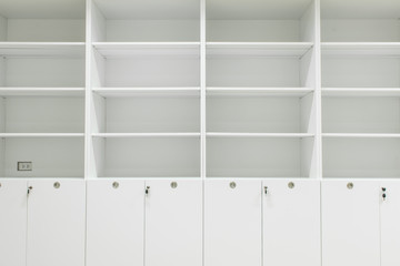 White cabinet and shelves in room.