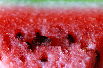 macro shot of ripe, juicy, red watermelon with black and white ossicle 