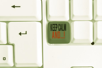 Text sign showing Keep Calm And. Business photo text motivational poster produced by British government White pc keyboard with empty note paper above white background key copy space