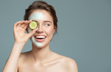 Portrait of beautiful woman with blue cream mask on her face.