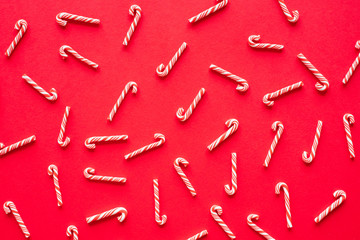 Candy cane on red background for chirstmas and happy new year concept. flatlay topview.