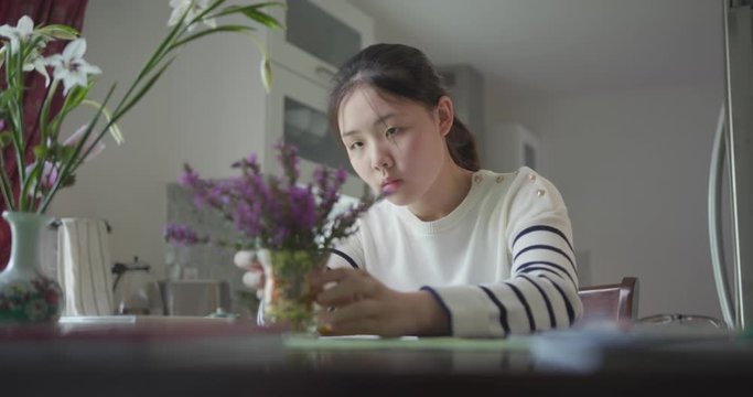 Young Asian Girl Sketching Flowers