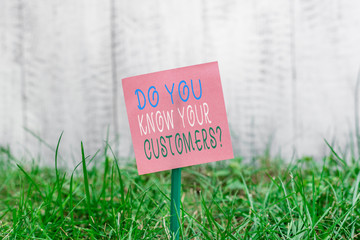 Writing note showing Do You Know Your Customers question. Business concept for asking to identify a customer s is nature Plain paper attached to stick and placed in the grassy land