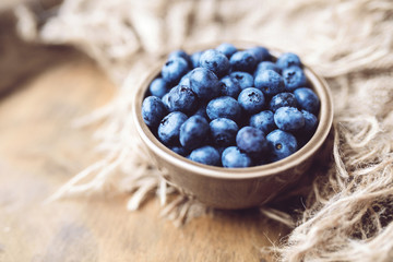 Fresh ripe blueberries in a bowl, vintage look 