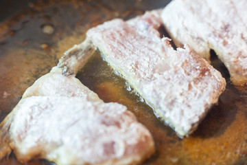 Fried fish in a pan. Fish fillet crucian, fried in a pan with sunflower oil for eating. Delicious food.